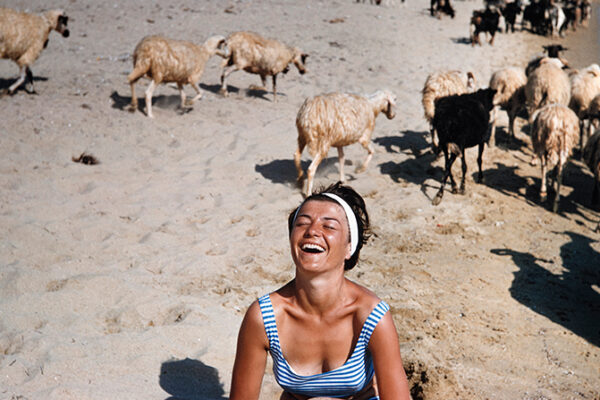 Γαλλίδα τουρίστρια στην εκπληκτική παραλία Μαγγανάρι της Ίου μαζί με ένα κοπάδι πρόβατα